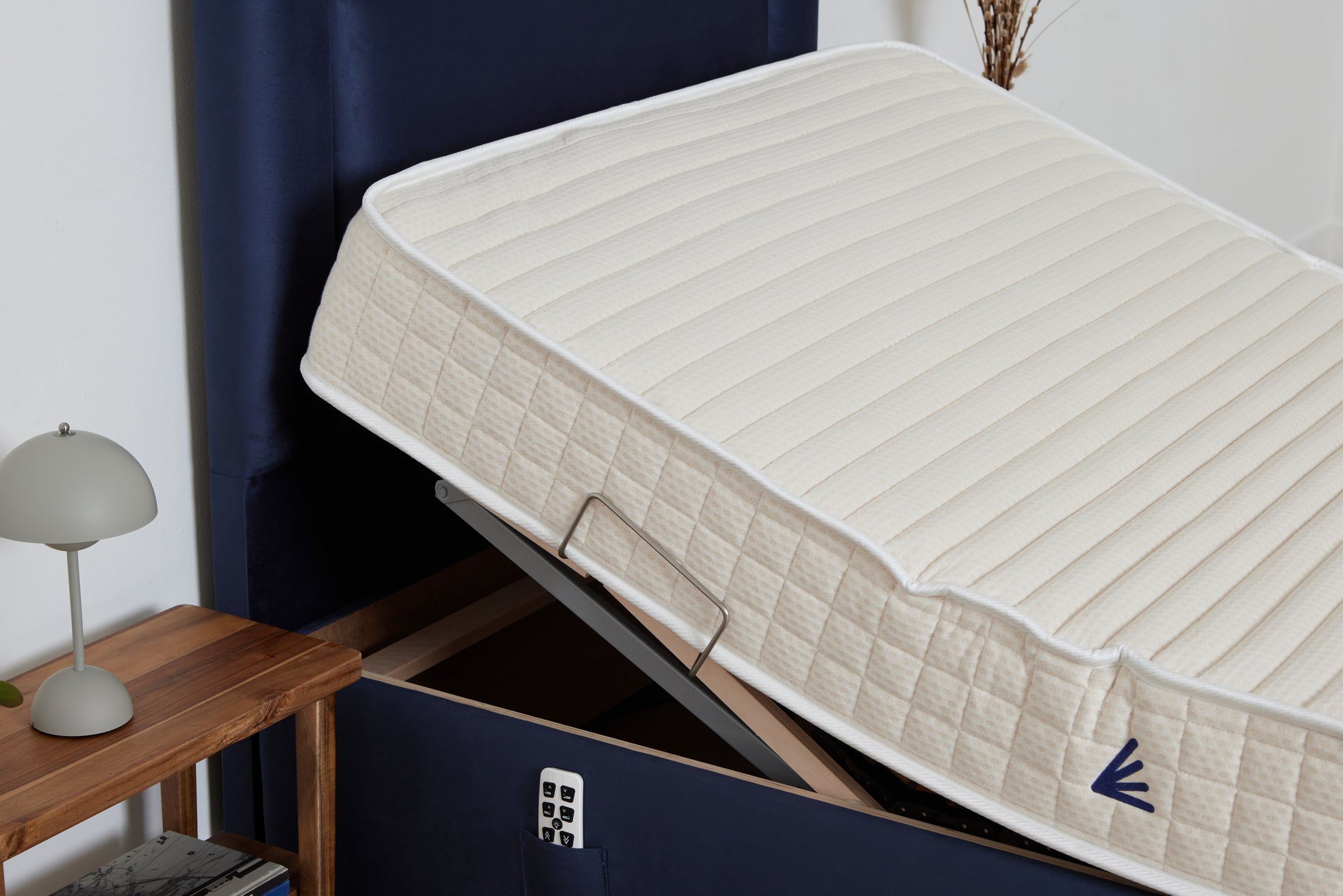 Navy upholstered single 4ft electric adjustable bed made in Ireland by the natural sleep company pressure relieving mattress raised at the head elevated with remote control 